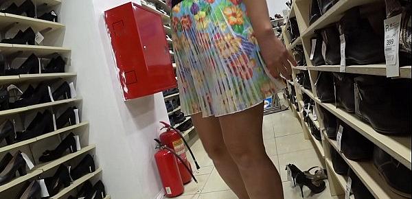  A voyeur with a hidden camera in a public place watches juicy booty. Foot fetish and peeping under a skirt in a shoe store.
